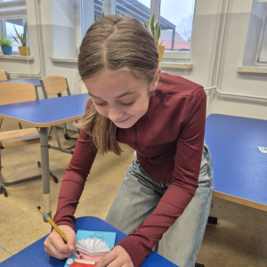 3.	Uczennica rysuje detale na przygotowanej kartce.